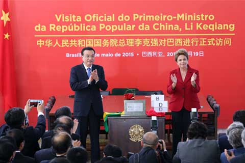 Premier Li Keqiang and Brazilian President Dilma Rousseff attend a ceremony for a China-backed hydropower project in Brasilia in May