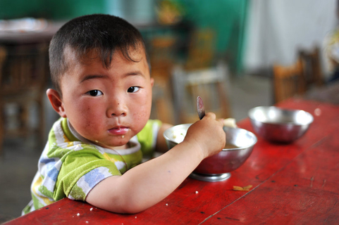 A youngster digs into his lunch at a rural kindergarten in Yuncheng, in the northern province of Shanxi