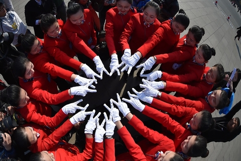 2016年3月14日，2016年全国两会正在北京举行，下午15时，全国政协十二届四次会议在人民大会堂举行闭幕会，广场上的美女礼仪摆出各种队形和姿势拍照，“中国红”鲜艳夺目。 东方IC