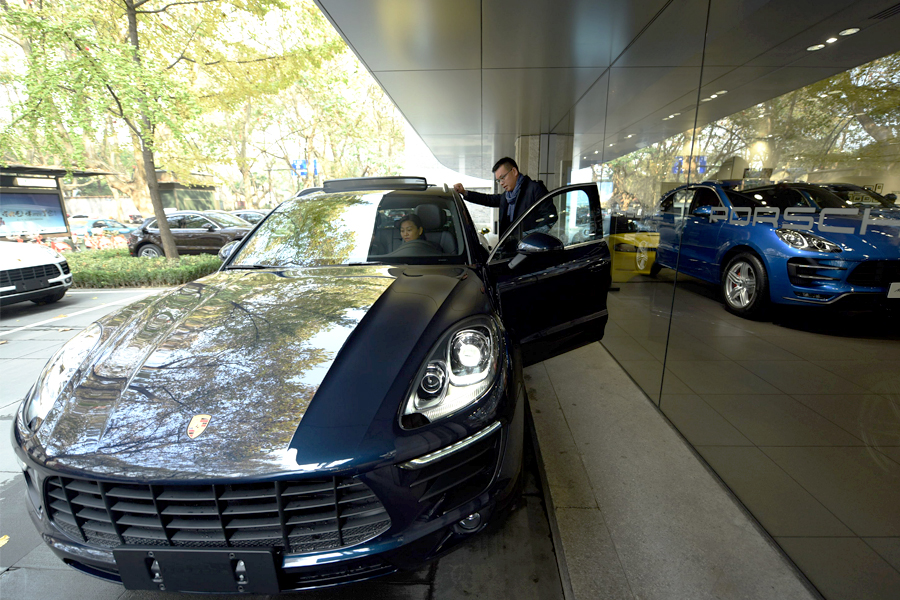 A car shopper takes out a Porsche for a test drive from a 4S auto dealership in Hangzhou, Zhejiang province. Photo: IC