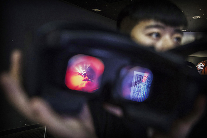 Virtual reality (VR) glasses are displayed at the Choice VR Park at a Beijing mall in November. Three years after Facebook bought VR startup Oculus for $2 billion and launched interest from investors and startups, the industry is cooling off as anticipated public demand has yet to materialize. Photo: Visual China