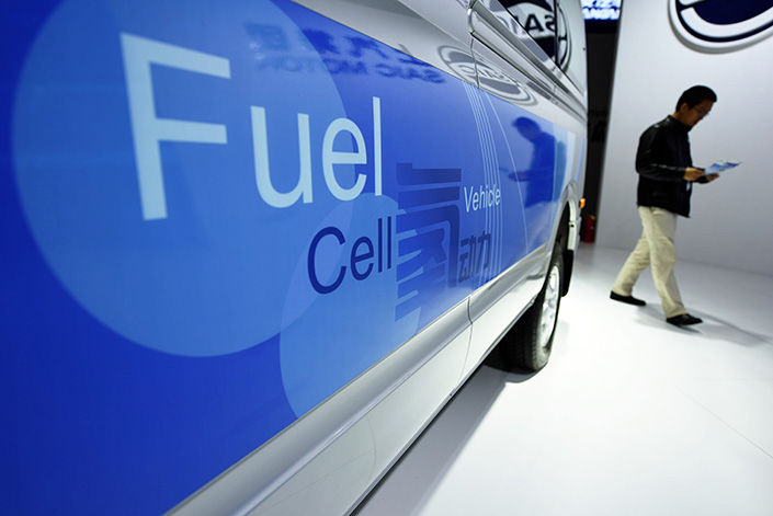 A visitor walks past a new-energy car at the China International Industry Fair in November 2016. Sales of new-energy vehicles plunged 70% in January, affected by seasonal factors and cutbacks in government subsidies. Photo: IC