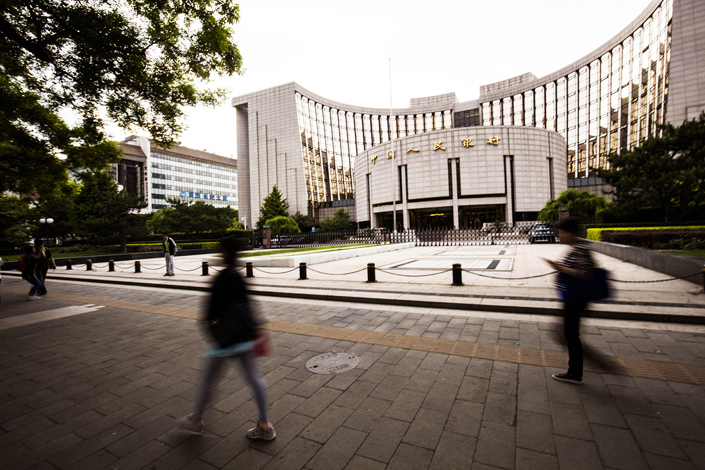 The People's Bank of China has issued a research paper that says market forces need to play the decisive role in reducing the debt in the country. Photo: IC