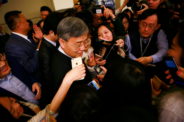 Guo Shuqing, the new chairman of the China Banking Regulatory Commission (CBRC), is surrounded by reporters in Beijing on March 2 after his first news conference as the new head of China's banking regulator. Guo, 60, faces formidable challenges as chairman of the China Banking Regulatory Commission. Photo: IC