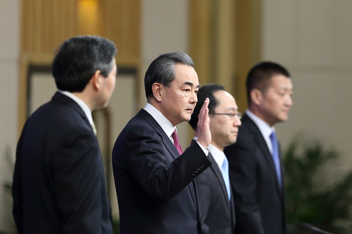 Foreign Minister Wang Yi answers questions at a news conference at the Media Center in Beijing on Wednesday. Wang criticized South Korea's decision to deploy the  Terminal High Altitude Area Defense anti-missile system as 