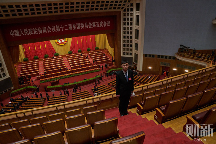 Security personnel stand guard on March 3 in the Great Hall of the People after the opening ceremony of the fifth session of the 12th National Committee of the Chinese People's Political Consultative Conference (CPPCC). Photos: Liang Yingfei/Caixin