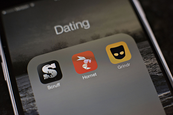 Gay dating apps Scruff, Hornet, and Grindr are displayed on an iPhone in Tiskilwa, Illinois, in the United States, on Jan. 20, 2015. Photo: Visual China