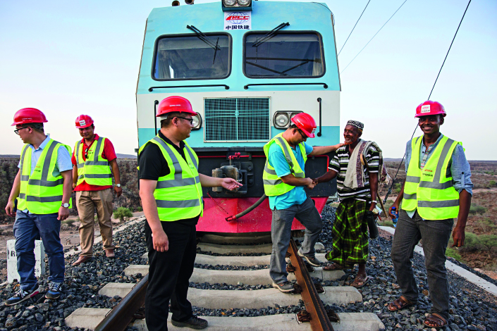 A local resident talks with staff of the Addis Ababa–Djibouti Railway in Ethiopia, on Sep. 28, 2016. The railway was built by the China Railway Group Limited, with a total investment of about $40 billion. Photo: IC