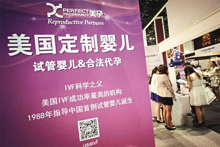 A surrogacy agency introduces test tube baby service and legal surrogate in U.S. to their Chinese customers in an exhibition in Beijing, on July 4, 2014.