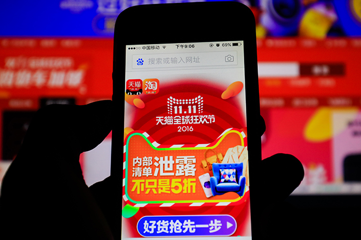 A customer browses Alibaba’s Tmall Global website on a smartphone. The e-commerce giant is looking to expand into Hong Kong, Taiwan, Singapore and Malaysia. Photo: Visual China