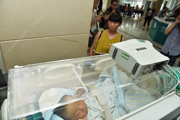 A 1-month-old boy, Chunchun, gets treated on Sunday at West China Hospital of Sichuan University in Chengdu, Sichuan province. The boy's timely cries alerted his parents to the approaching landslide early Saturday morning in the village of Xinmo in Sichuan. Photo: Visual China