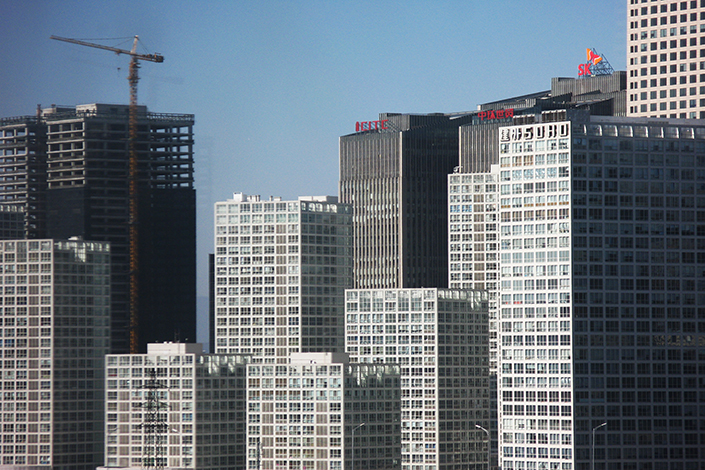 Chinese real estate developers have been issuing one-year bonds overseas since late May to bypass government measures to curb one of their favorite fundraising channels.  Photo: Visual China