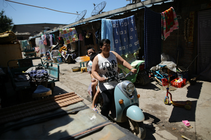 Qiuxian village in Beijing’s Daxing district has ordered migrant workers living there to pay a fee of 2,000 yuan a month, but some experts question the legality of the measure. Above, Beijing's rural Changping district also has targeted migrants in an effort to reduce the population, with authorities closing schools for the workers' children. Photo: IC