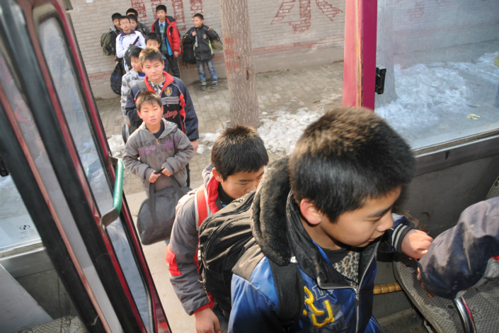 The deaths of four Hebei province preschoolers within two weeks after being locked in sweltering school buses has provoked outrage nationwide. Above, students of Qiaodong No.3 School board a school bus after class in Xingtai, Hebei province, in December 2011. Photo: Visual China