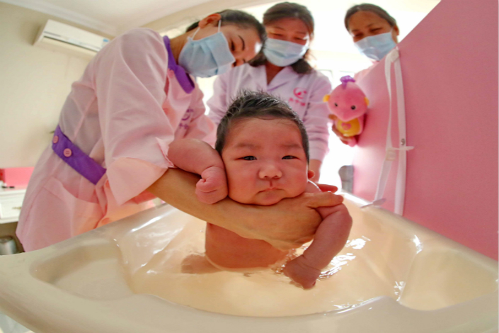 China's growing services sector reached a milestone in 2015, when it accounted for more than 50% of gross domestic product. Above, a nursing employee bathes a newborn at a postpartum care center in Qinhuangdao, Hebei province, on March 29. Photo: IC