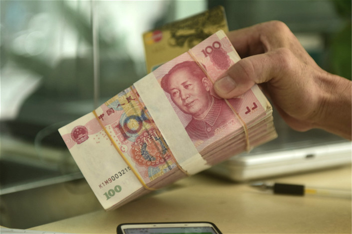 As of the end of June, the outstanding value of wealth management products sold among financial institutions dropped 31% to 4.61 trillion yuan ($699 billion) from the end of December. Photo: Visual China