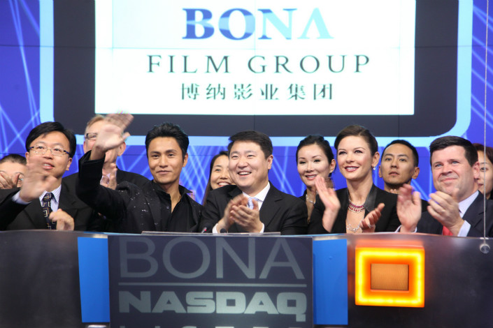 As several domestic media and technology firms seek listings overseas, NASDAQ-traded Chinese filmmaker Bona is planning to raise up to 1.425 billion yuan ($212 million) in China.  Pictured above is Bona founder and CEO Yu Dong standing between Chinese actor Chen Kun and Welsh star Catherine Zeta-Jones. Photo: Visual China
