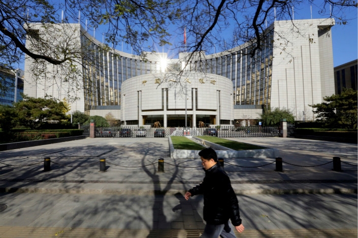 The first task of Financial Stability and Development Committee, whose members include representatives from the People’s Bank of China (pictured) and other financial regulators, will be to draft laws and regulations to clearly state the responsibilities of the central bank and the regulators in combating ballooning financial risks, a source told Caixin. Photo: Visual China