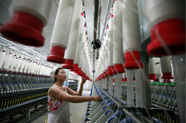 The official Manufacturing Purchasing Managers Index fell to 51.6 in October, the weakest reading since July. Above, a textile mill in Huaibei, Anhui province, creates textile products that are exported to Europe. Photo: Visual China