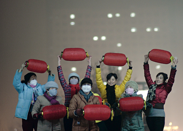 A national-level push that crossed regional and bureaucratic divides helped Beijing to meet its pollution reduction goal in 2017. Above: In December 2016, residents in Shijiazhuan, Heibei province, practice group dance on a heavily polluted day. Photo: Caixin