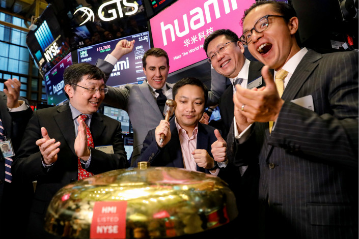 Huami Corp. CEO Wang Huang rings the opening bell at the New York Stock Exchange to mark his company's listing on the bourse on Feb. 8. Huami shares finished their first trading day on Thursday at $11.25, up about 2.3% from their initial public offering price. Photo: VCG
