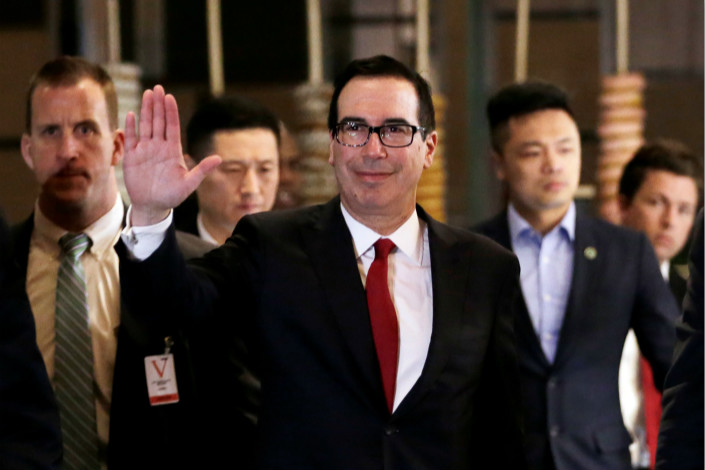 U.S. Treasury Secretary Steven Mnuchin, a member of the U.S. trade delegation to China, waves to the media as he returns to a hotel in Beijing on Thursday. Photo: VCG