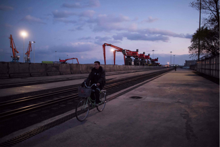 A man cycles past a railway in the Rason Special Economic Zone in North Korea on Nov. 21.. Photo: VCG