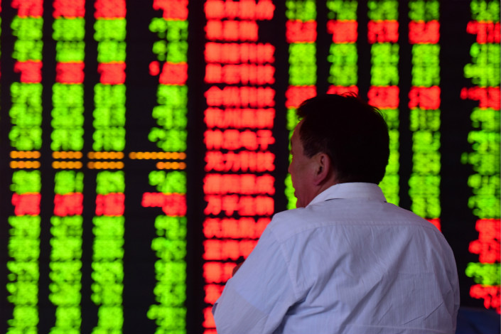 An investor watches stock data at a securities business hall in Fuyang, Anhui province on May 11. Photo: VCG