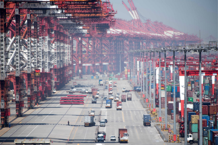 Cargo is loaded and unloaded at Yangshan Deep-Water Port in Shanghai on April 9. Photo: VCG
