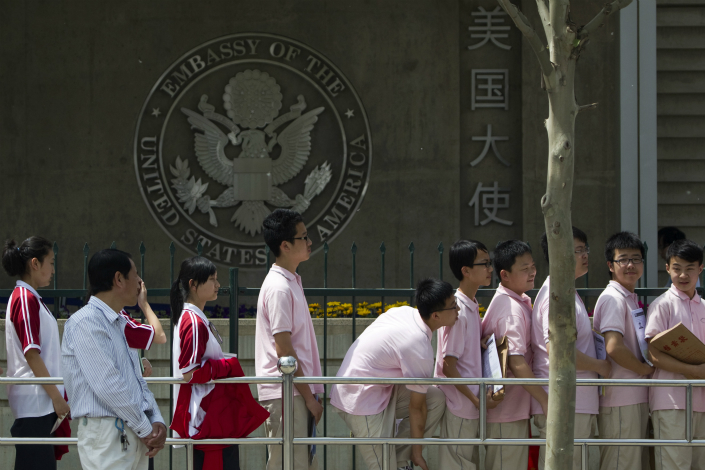 Students wait outside the U.S. Embassy in Beijing for their visa application interviews in May 2017. Photo: VCG