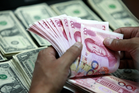Companies are buying more foreign currencies and selling less as expectations increase that the yuan will depreciate, analysts say. Photo: VCG