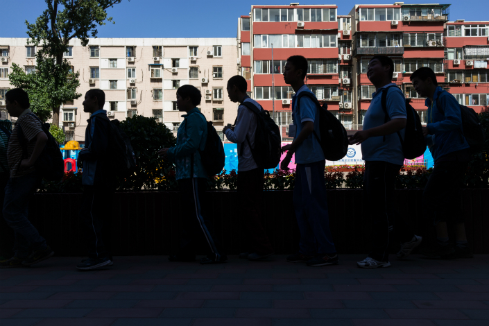 Middle school students return from school in Beijing in May. Photo: VCG