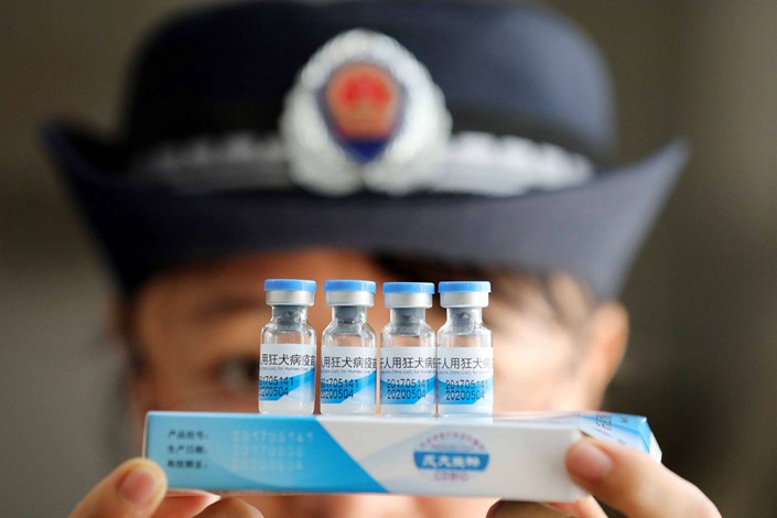 A law enforcement officer examines bottles of rabies vaccine on Monday at a warehouse of a disease control and prevention center in South China’s Guangxi Zhuang autonomous region. Photo: IC
