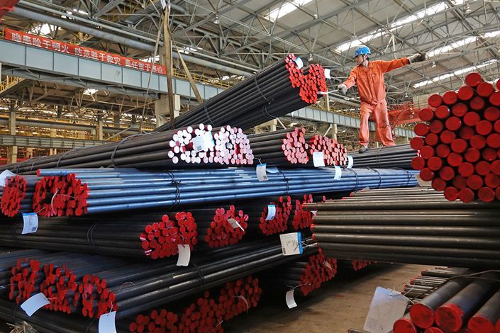 A worker moves steel pipe in a warehouse in the northeastern city of Dalian on June 21. Photo: VCG