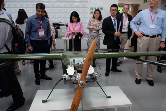 Visitors inspect a surveilance drone at an innovation park in Chengdu, Sichuan province, in April. Photo: Wu Gang/Caixin