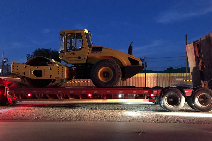 A road roller is transported in Beijing in June. Photo: Wu Gang/Caixin