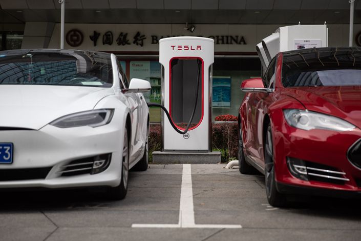 Tesla automobiles recharge in front of the Tesla China headquarters in Beijing on July 25. Photo: IC
