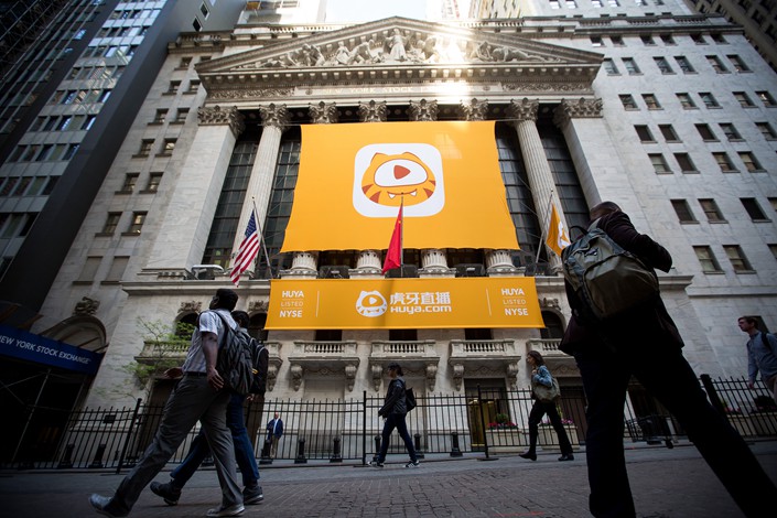 Huya Inc. banners hang from the New York Stock Exchange ahead of its listing on May 11. Photo: VCG