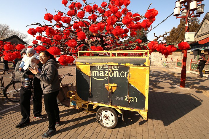 A China Amazon delivery vehicle is parked outside a Beijing park on Feb. 5.  Photo: VCG