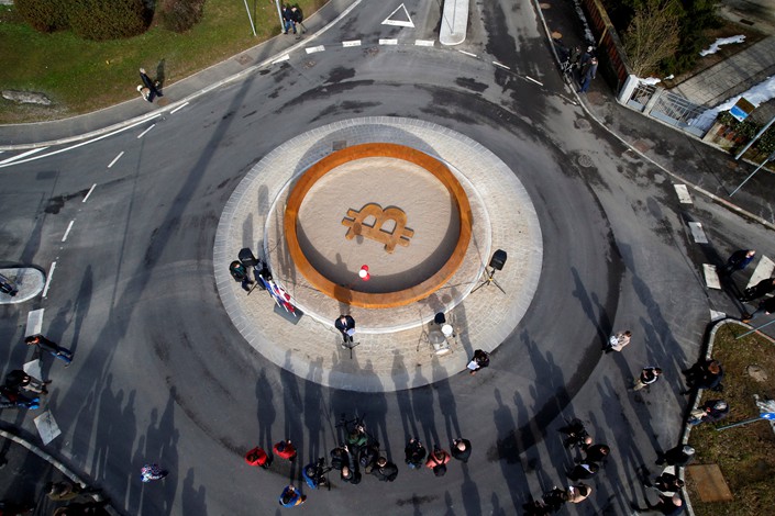 People attend the opening ceremony of world's first public bitcoin monument, placed at a roundabout in the center of the city of Kranj, Slovenia on March 13. Photo: VCG