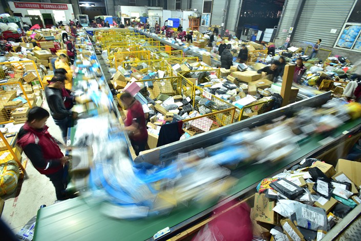 Workers sort parcels on Nov. 16 in the city of Neijiang in Sichuan province. Photo: VCG