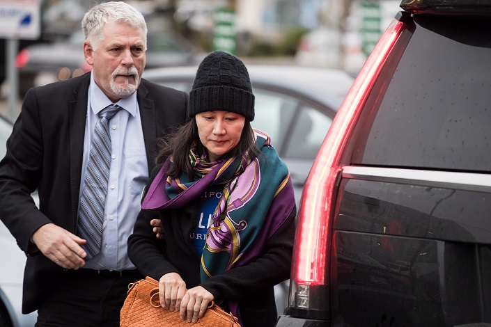 Huawei chief financial officer Meng Wanzhou, right, arrives at a parole office with a member of her private security detail in Vancouver, on Wednesday Dec. 12, 2018. Photo: VCG