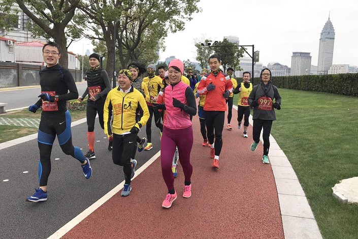 Paul Mui (front row, in yellow), originally from Hong Kong, is the founder of the running group Lao Mei — which means “Old Mr Mui” — in Shanghai. “Pao tuan,” or running groups, in China play a big part in spreading the popularity of the sport. They are usually informal interest groups, unlike running clubs overseas that tend to be more professional. Photo: Lao Mei