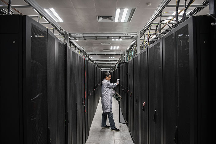 A Huawei engineer opens the door of a server unit at the Cyber Security Lab in Dongguan, Guangdong province, on April 25, 2019. Photo: VCG