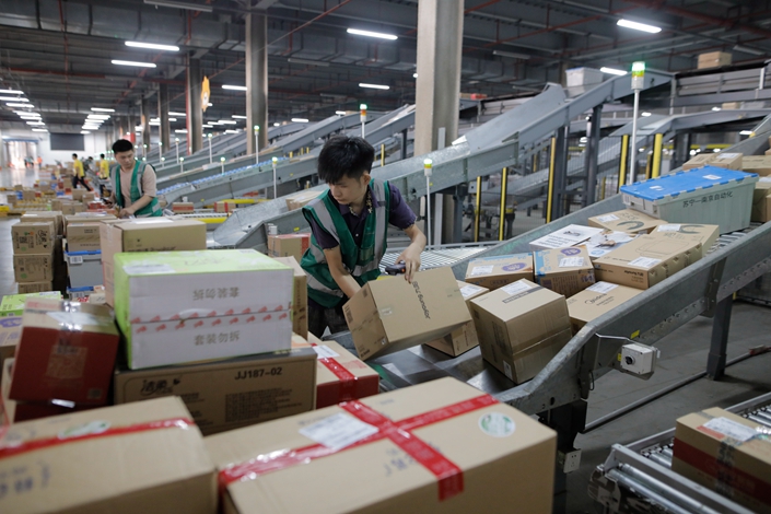 Workers sort goods at a Suning warehouse in Nanjing, Jiangsu province, on June 27. Photo: IC Photo