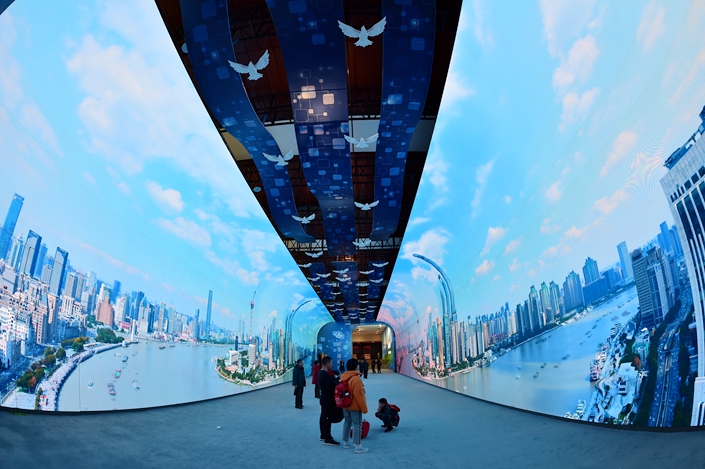 Tourists visit an exhibition about economic reform in the National Museum of China in Beijing on Feb 5. Photo: VCG