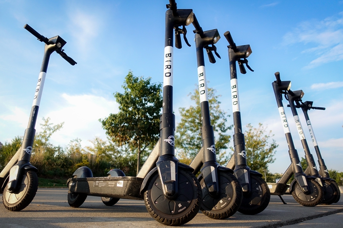 Sharable electric scooters by Bird Rides, Inc. wait on downtown sidewalks for pedestrian use on Oct. 2 in downtown Cincinnati, Ohio. Photo: IC Photo