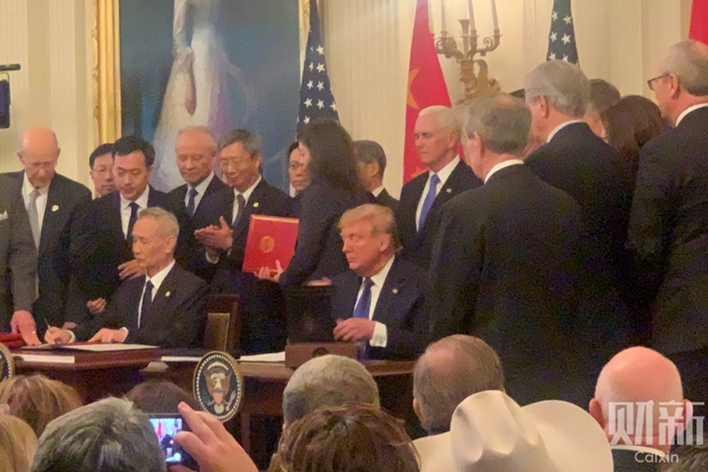 U.S. President Donald Trump and Chinese Vice Premier Liu He sign the China-U.S. phase one trade deal at a ceremony in the East Room of the White House in Washington on Wednesday. Photo: Zhang Qi/Caixin