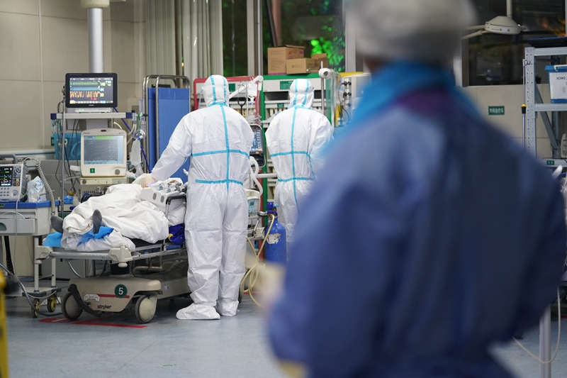 Doctors apply treatment to a patient in the intensive care unit at the South Central Hospital in Wuhan on Feb. 4