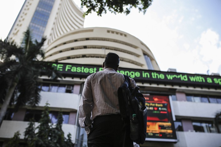 A person looks at a ticker board outside the Bombay Stock Exchange on March 9. Photo: VCG